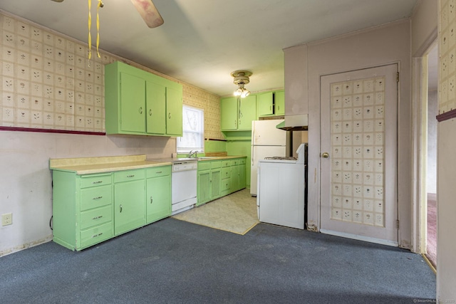 kitchen featuring dark carpet, dishwasher, light countertops, stove, and green cabinetry