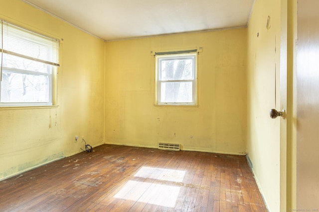 spare room featuring visible vents and wood-type flooring