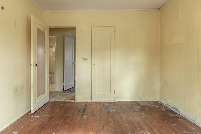 spare room featuring wood-type flooring