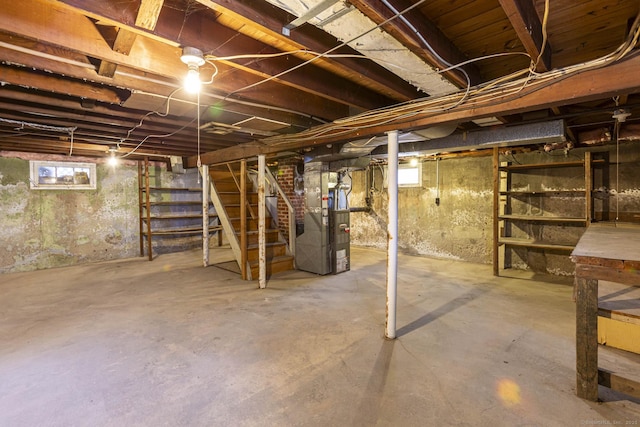 basement featuring heating unit and stairs