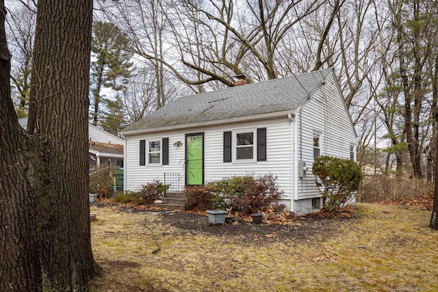 view of front of property featuring a shingled roof and a chimney