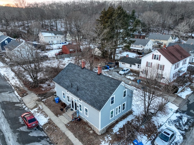 snowy aerial view with a residential view