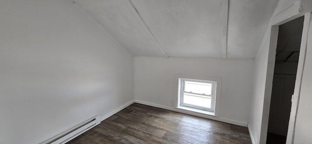 additional living space with dark wood-type flooring, vaulted ceiling, baseboards, and a baseboard radiator