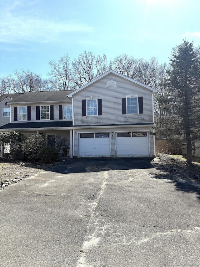 view of front of house featuring aphalt driveway and an attached garage