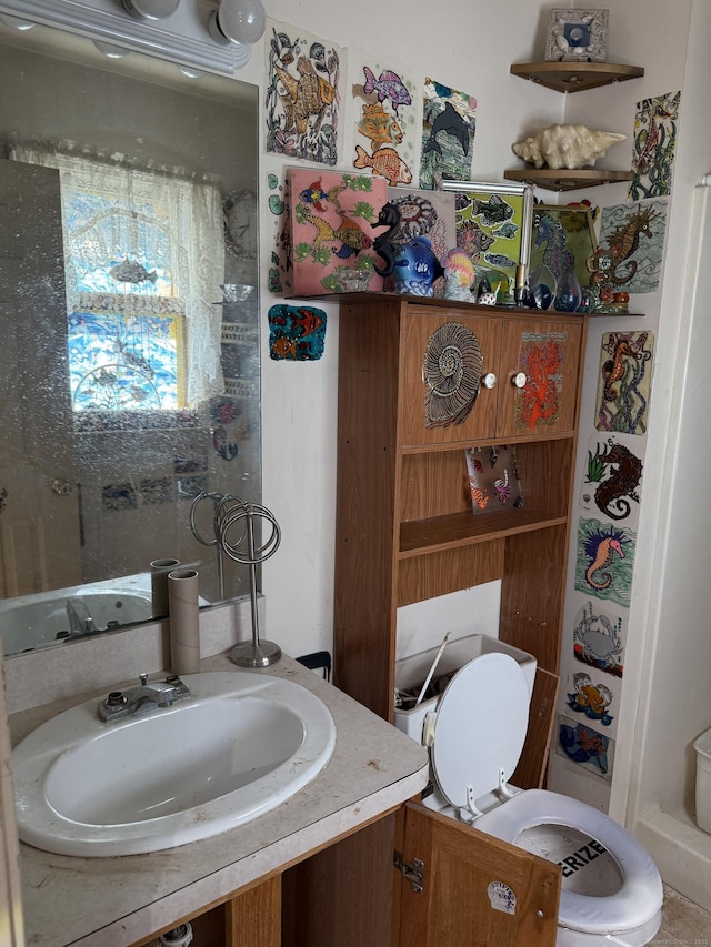 bathroom with toilet and vanity