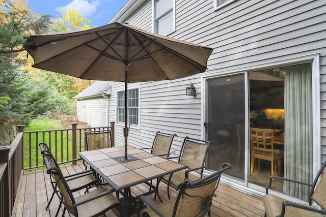 wooden deck featuring outdoor dining area