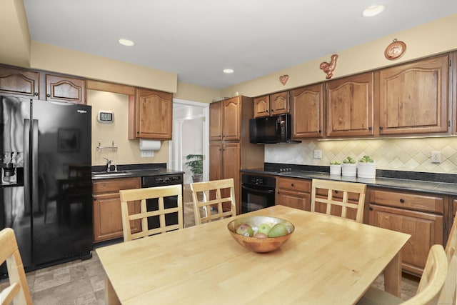 kitchen with black appliances, beverage cooler, a sink, dark countertops, and decorative backsplash