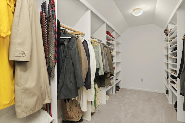 walk in closet with carpet flooring and lofted ceiling