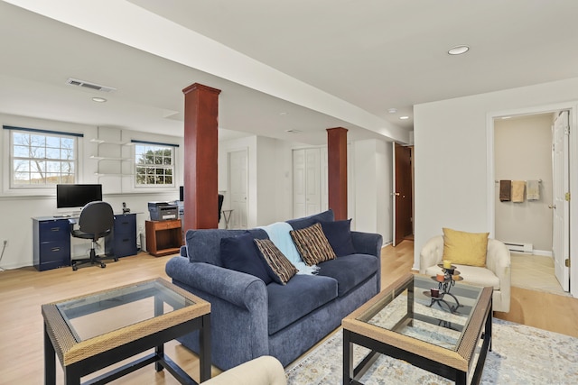 living room with recessed lighting, visible vents, light wood-style flooring, and decorative columns