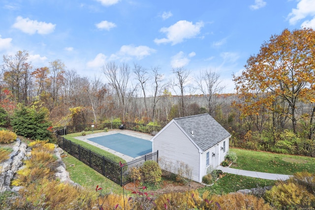 view of pool featuring an outbuilding, a yard, and fence