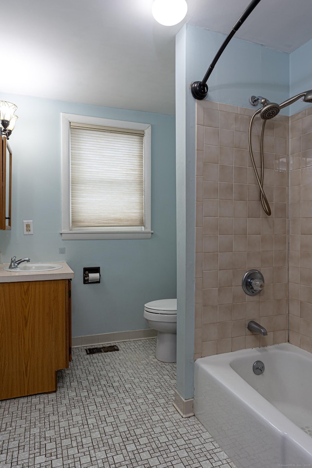 bathroom featuring vanity, baseboards, visible vents, toilet, and shower / bathtub combination