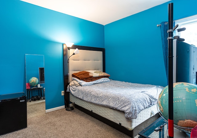 bedroom featuring carpet and baseboards