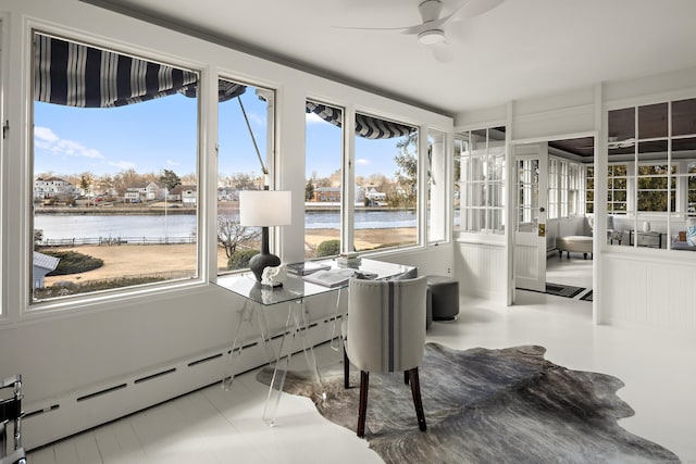 sunroom / solarium featuring a baseboard heating unit, plenty of natural light, a water view, and ceiling fan