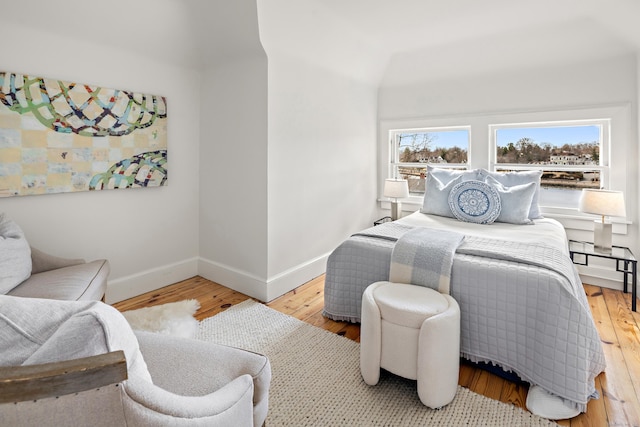 bedroom featuring baseboards and hardwood / wood-style floors