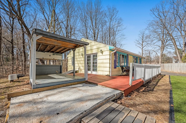 wooden terrace featuring fence