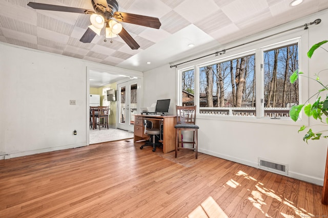 office area featuring visible vents, baseboards, a ceiling fan, and wood finished floors