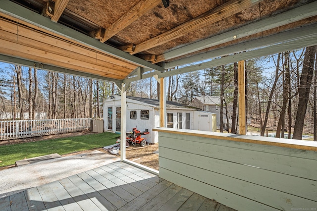 wooden terrace with an outbuilding and fence