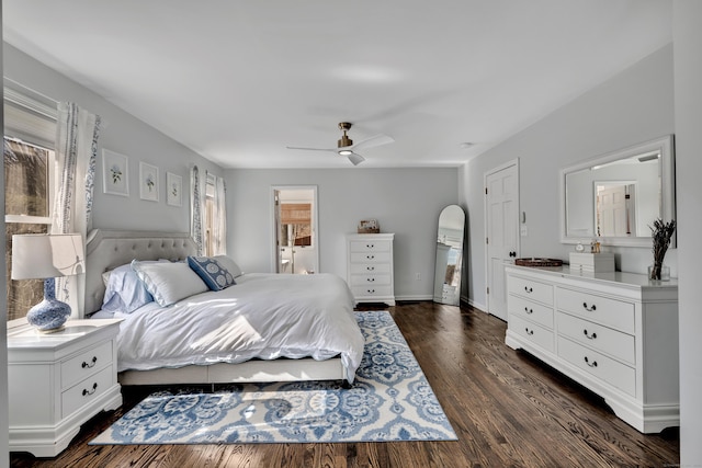 bedroom featuring dark wood-type flooring, ceiling fan, baseboards, ensuite bathroom, and arched walkways