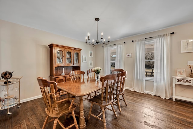 dining room featuring baseboards, a notable chandelier, and dark wood finished floors