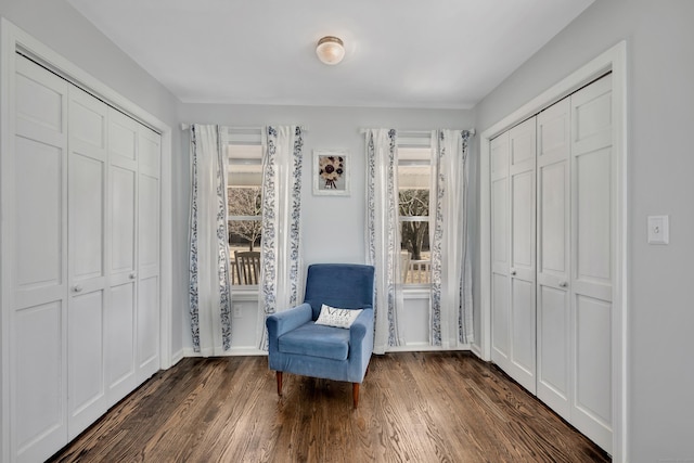 sitting room with baseboards and wood finished floors