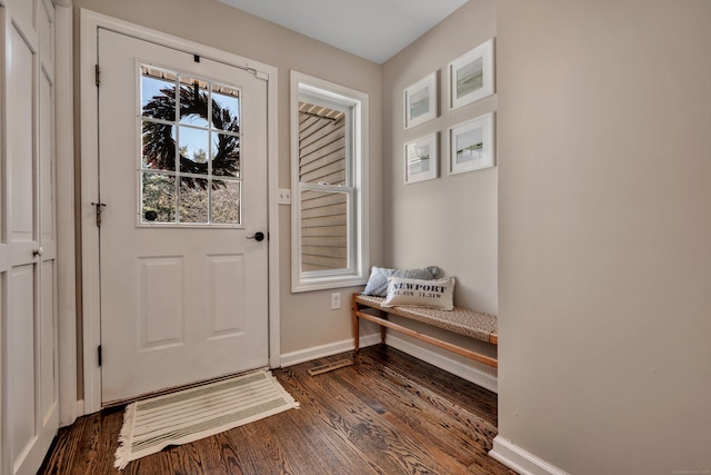 doorway to outside with baseboards and dark wood-style flooring