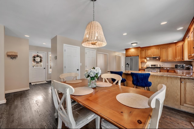 dining space with recessed lighting, baseboards, and dark wood-type flooring