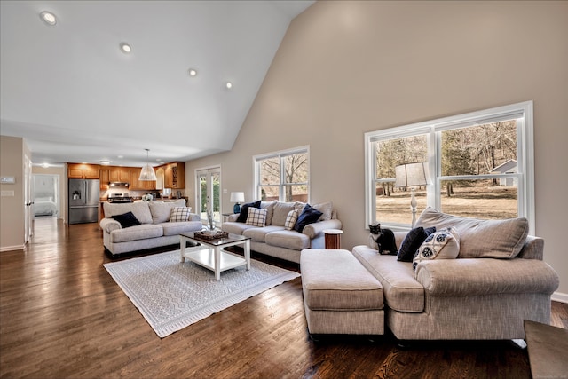 living room featuring recessed lighting, dark wood-style floors, baseboards, and high vaulted ceiling