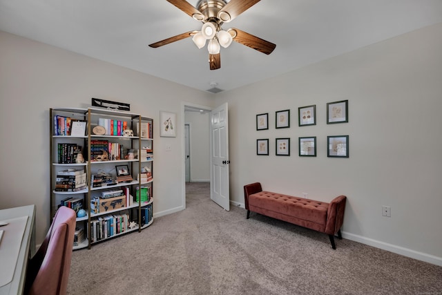 sitting room with carpet flooring, baseboards, and ceiling fan