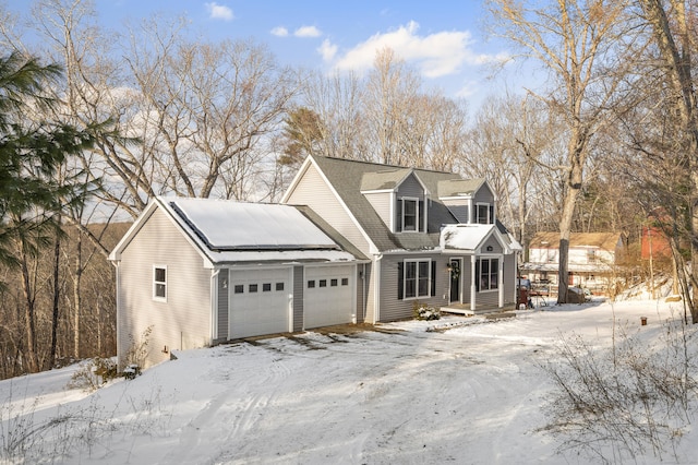 new england style home with an attached garage