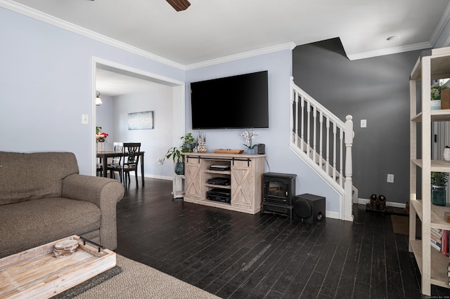 living area with baseboards, wood finished floors, stairs, and ornamental molding