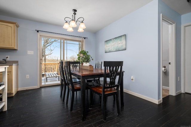 dining room featuring baseboards, an inviting chandelier, and dark wood finished floors