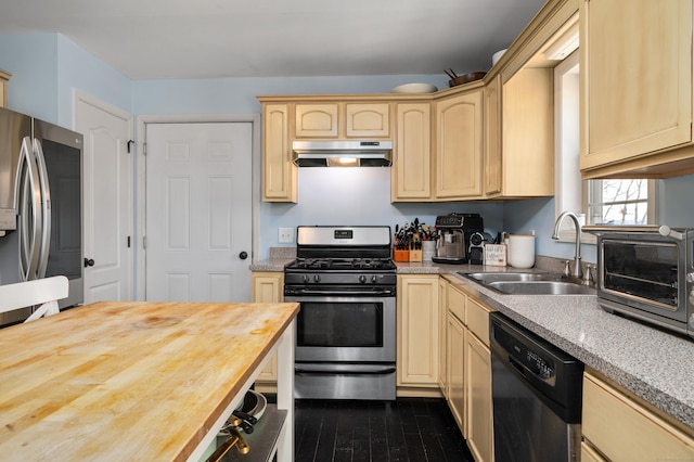 kitchen with light brown cabinets, a sink, stainless steel appliances, under cabinet range hood, and wood counters