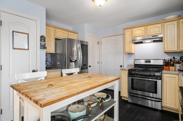 kitchen featuring under cabinet range hood, appliances with stainless steel finishes, butcher block counters, and light brown cabinets