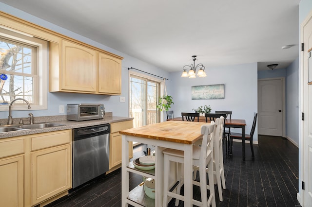 kitchen featuring light brown cabinets, a toaster, dishwasher, dark wood-style floors, and a sink