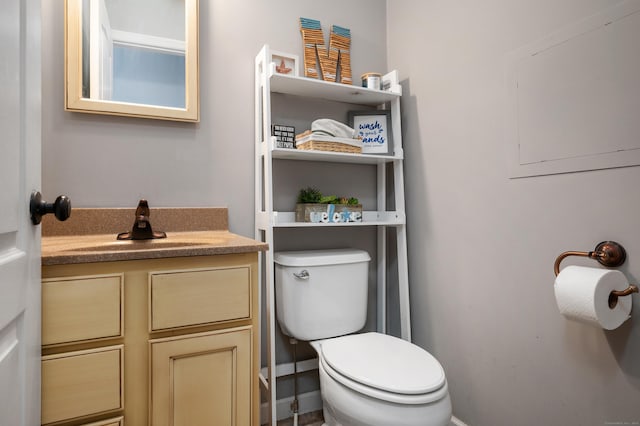 half bathroom with vanity and toilet