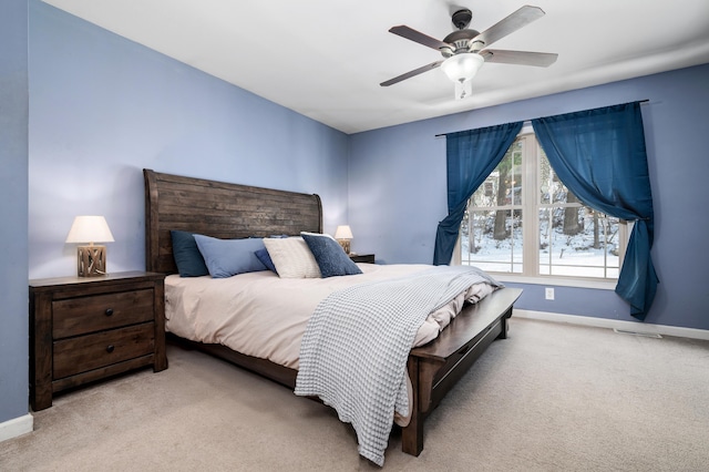 carpeted bedroom with baseboards and a ceiling fan