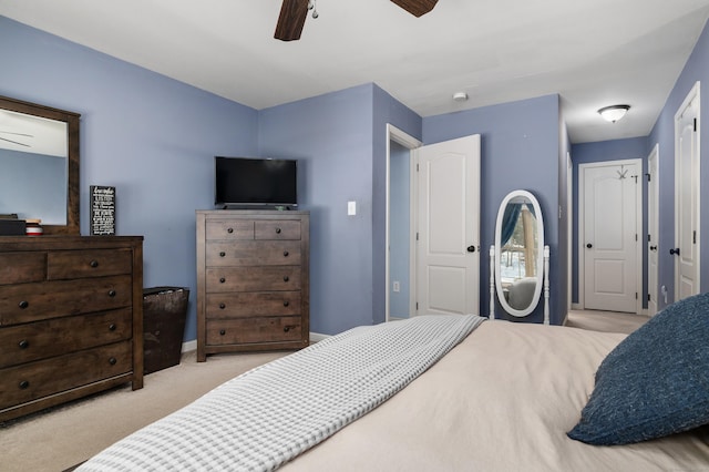 bedroom with carpet flooring, a ceiling fan, and baseboards