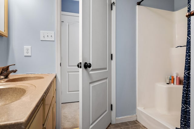 full bathroom featuring vanity and walk in shower