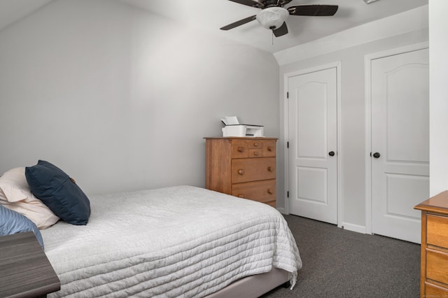 bedroom featuring dark colored carpet and a ceiling fan