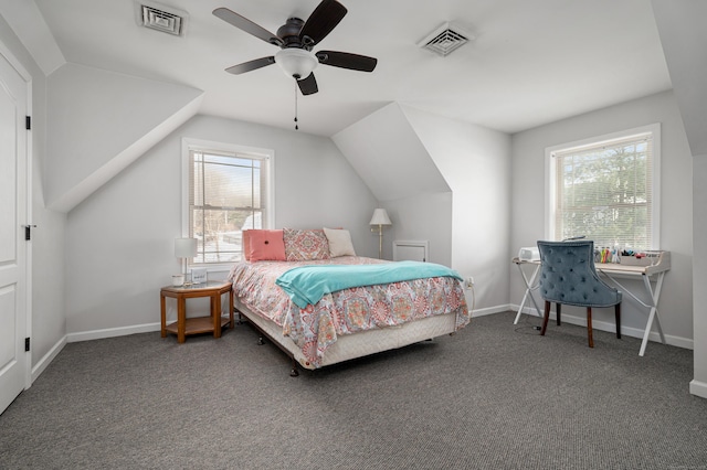 carpeted bedroom featuring lofted ceiling, multiple windows, and visible vents