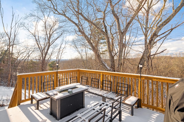 snow covered deck with an outdoor fire pit