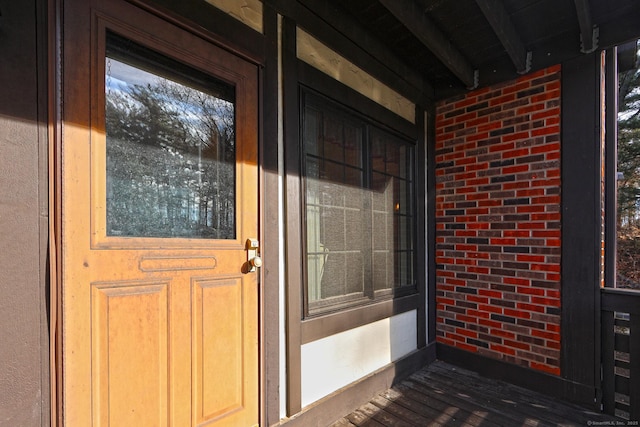 property entrance with brick siding