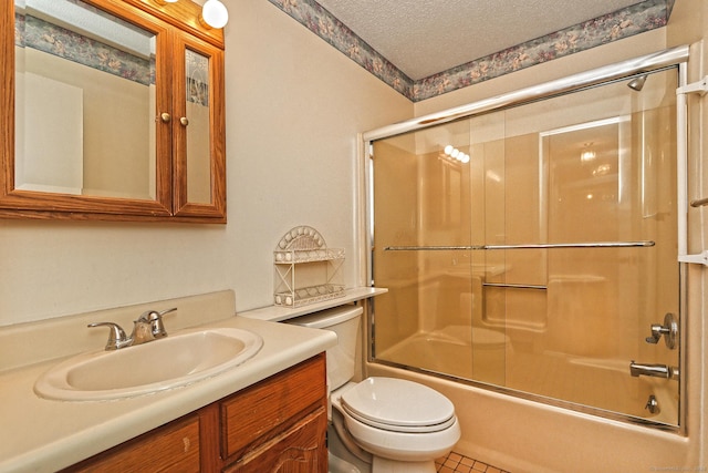 full bathroom featuring vanity, enclosed tub / shower combo, a textured ceiling, tile patterned floors, and toilet