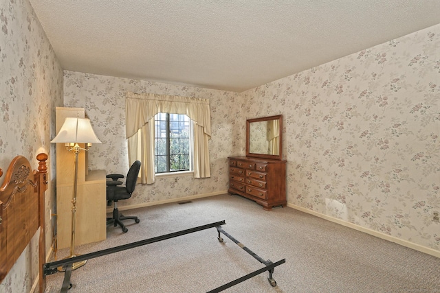 home office featuring baseboards, a textured ceiling, wallpapered walls, and carpet