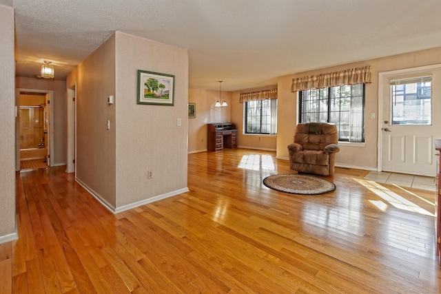 foyer featuring light wood-style floors and baseboards