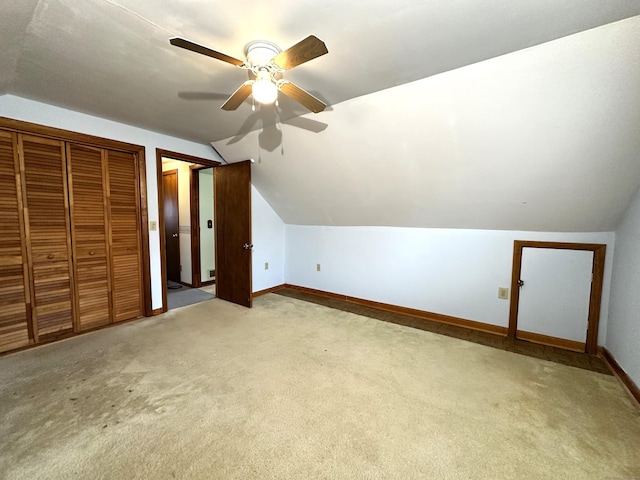 additional living space featuring baseboards, lofted ceiling, ceiling fan, and carpet flooring