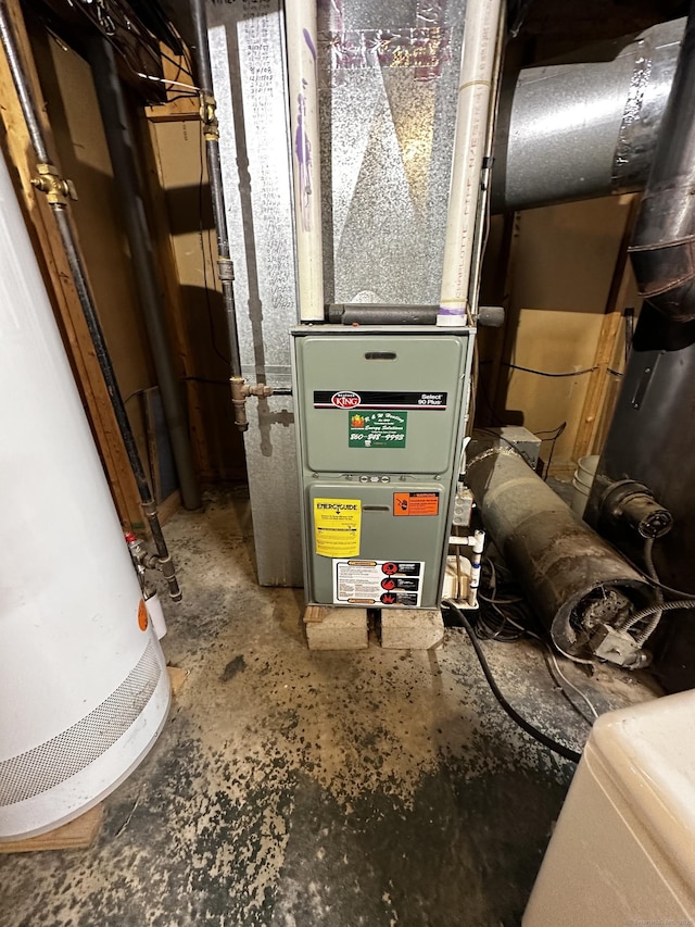 utility room featuring heating unit and water heater