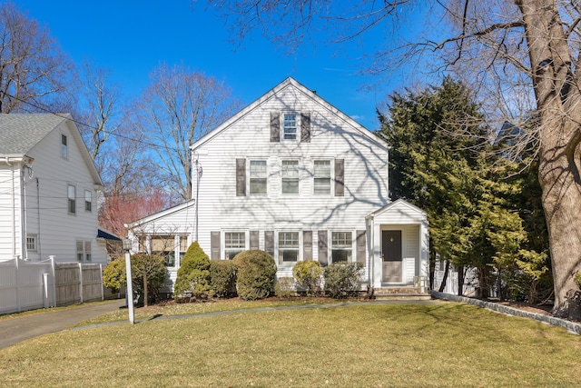 view of front of home featuring a front yard and fence