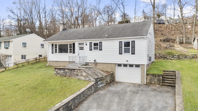 view of front of house featuring driveway, fence, a front yard, an attached garage, and a chimney