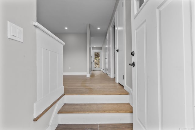 stairs featuring recessed lighting, baseboards, and wood finished floors